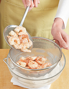 To stop the cooking process, transfer the cooked shrimp to an ice bath to cool, then drain.