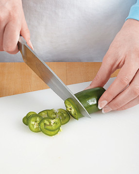 If you like spice, slice the jalape&ntilde;o. Otherwise, cut it in half lengthwise to remove all of the fiery seeds.