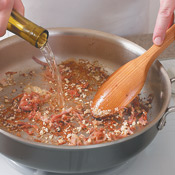 Use wine to deglaze the pan, scraping the bottom with a wooden spoon to release any browned bits. This adds flavor to the sauce.