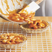 Pour the cashew-caramel mixture into the pastry shells. Let tarts cool before sprinkling with coarse salt. 