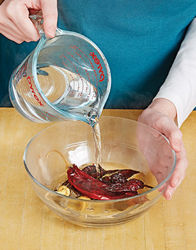 Soaking dried chiles in hot water softens their flesh so they’re easier to purée in the food processor.