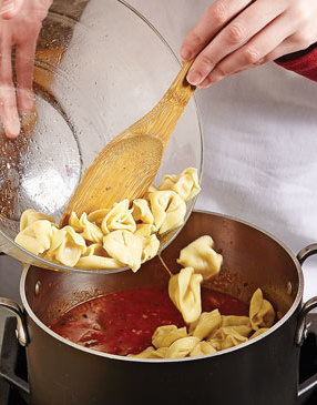 Since the tortellini cook quickly, boil them in the tomato sauce in a pot, not in the slow cooker.