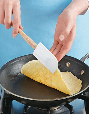 The pancakes are very pliable and should be easy to flip, but use your hand to help support them.