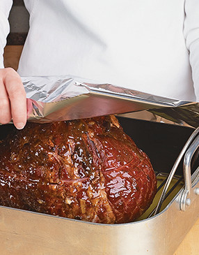 To keep the ham from drying out, tightly seal the pan with foil to trap the moisture in the roasting pan.