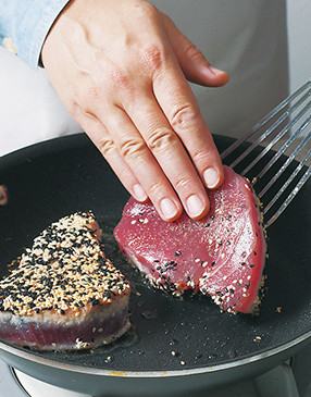Sear seeded side first, then flip tuna steaks and cook a few more minutes for medium.