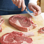 "French" the bones of the steaks by using the back of a small knife to scrape them clean. 