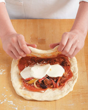 Stretch the dough up and over the filling, carefully pulling it to cover without tearing the dough.
