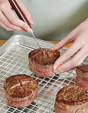 Using the tip of a sharp paring knife, cut an “X” into each seared filet. Be careful not to cut through the sides or bottoms of the filets. 