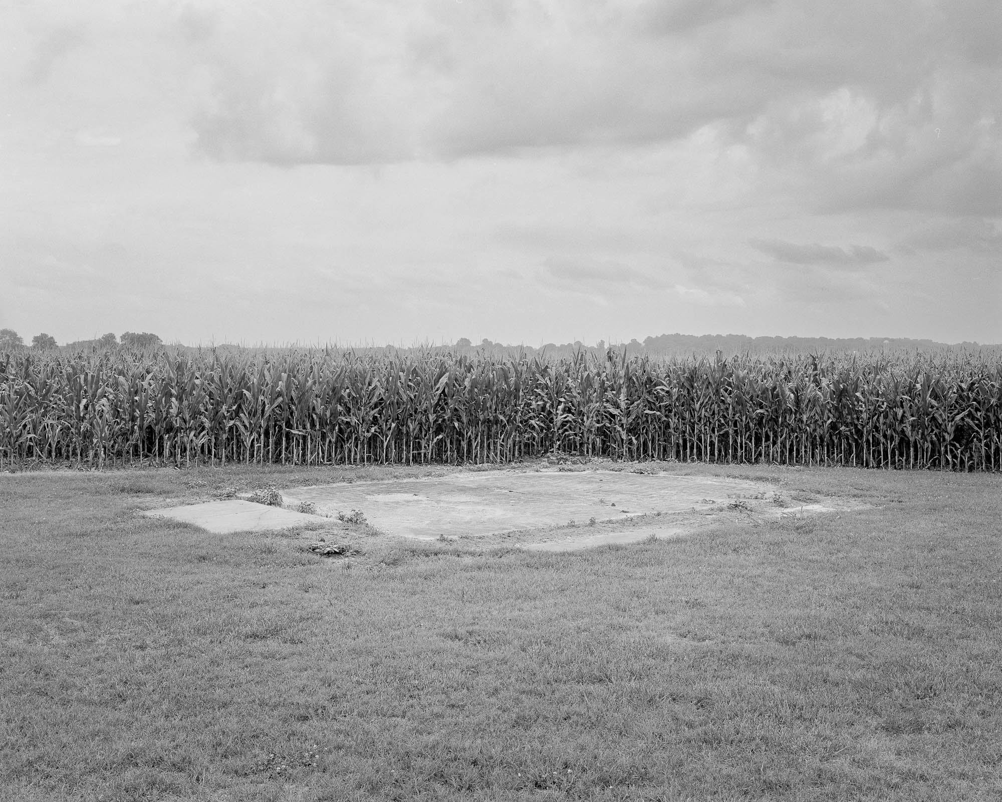 concrete slap in front of corn field