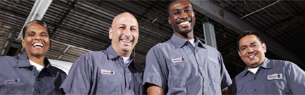 Four smiling men that work at Keller Heartt Oil