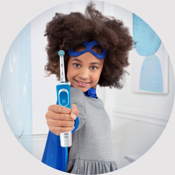 small girl holding oralB brush
