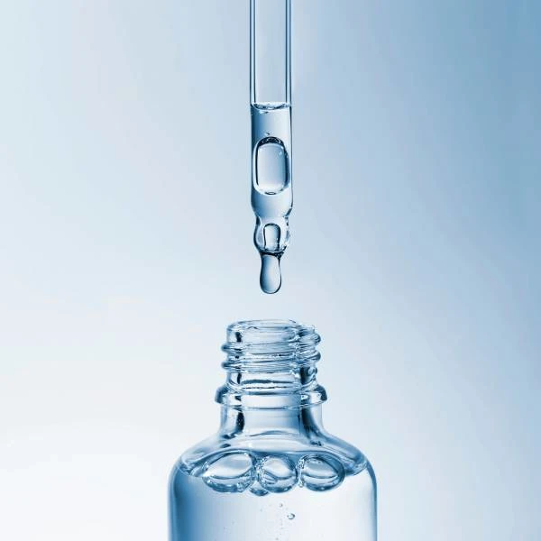 a bottle with pipette, containing a clear liquid