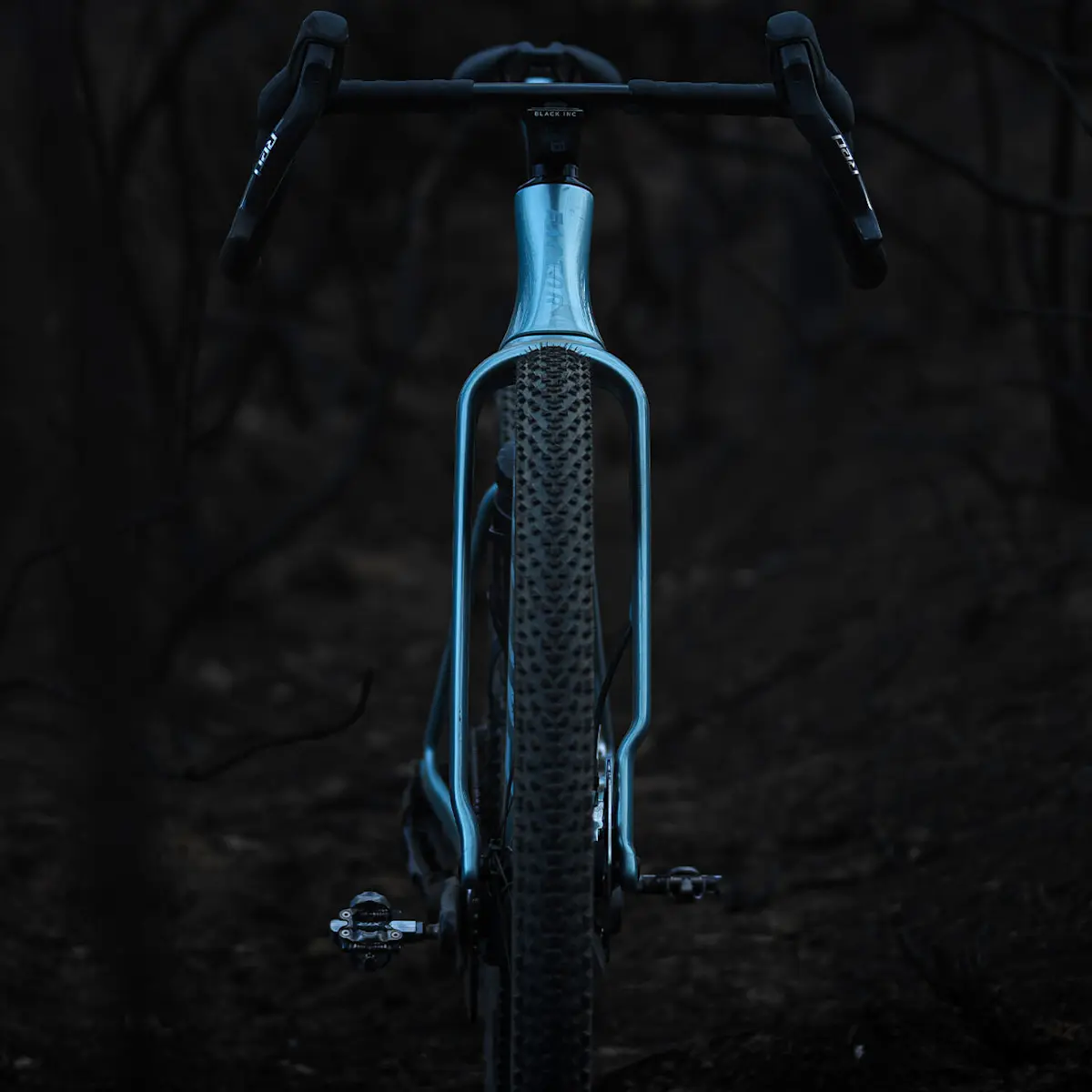 Full frontal view of the ELARA in Virescent Blue highlights the aero shape of the fork. Dark background.