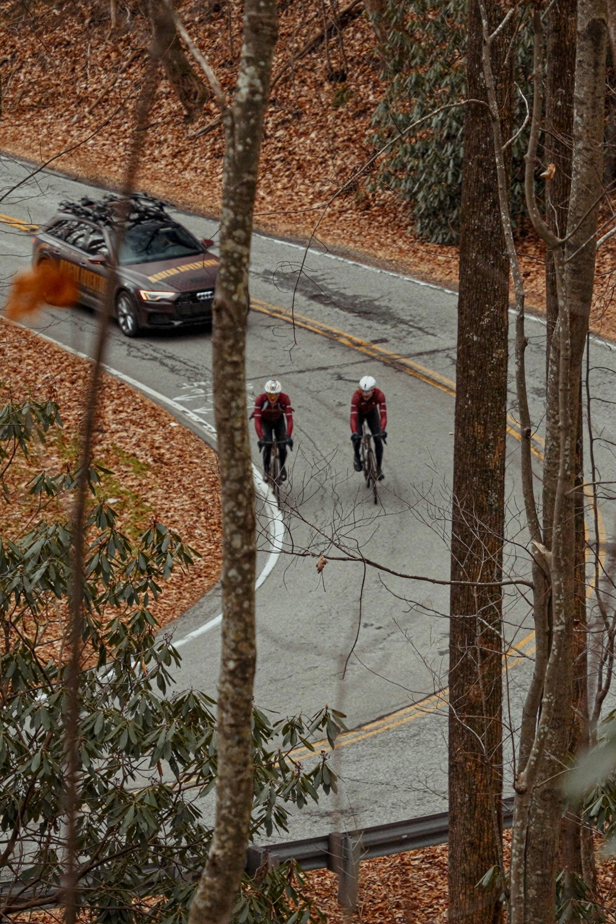 Modern Adventure team riders onboard their Factor OSTRO VAM's being followed by a team car
