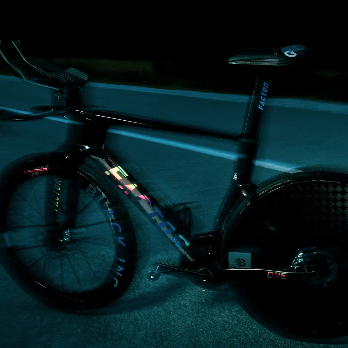 Darkly lit, slightly moody and out of focus non-drivetrain side view of the ONE SP in Chrome.