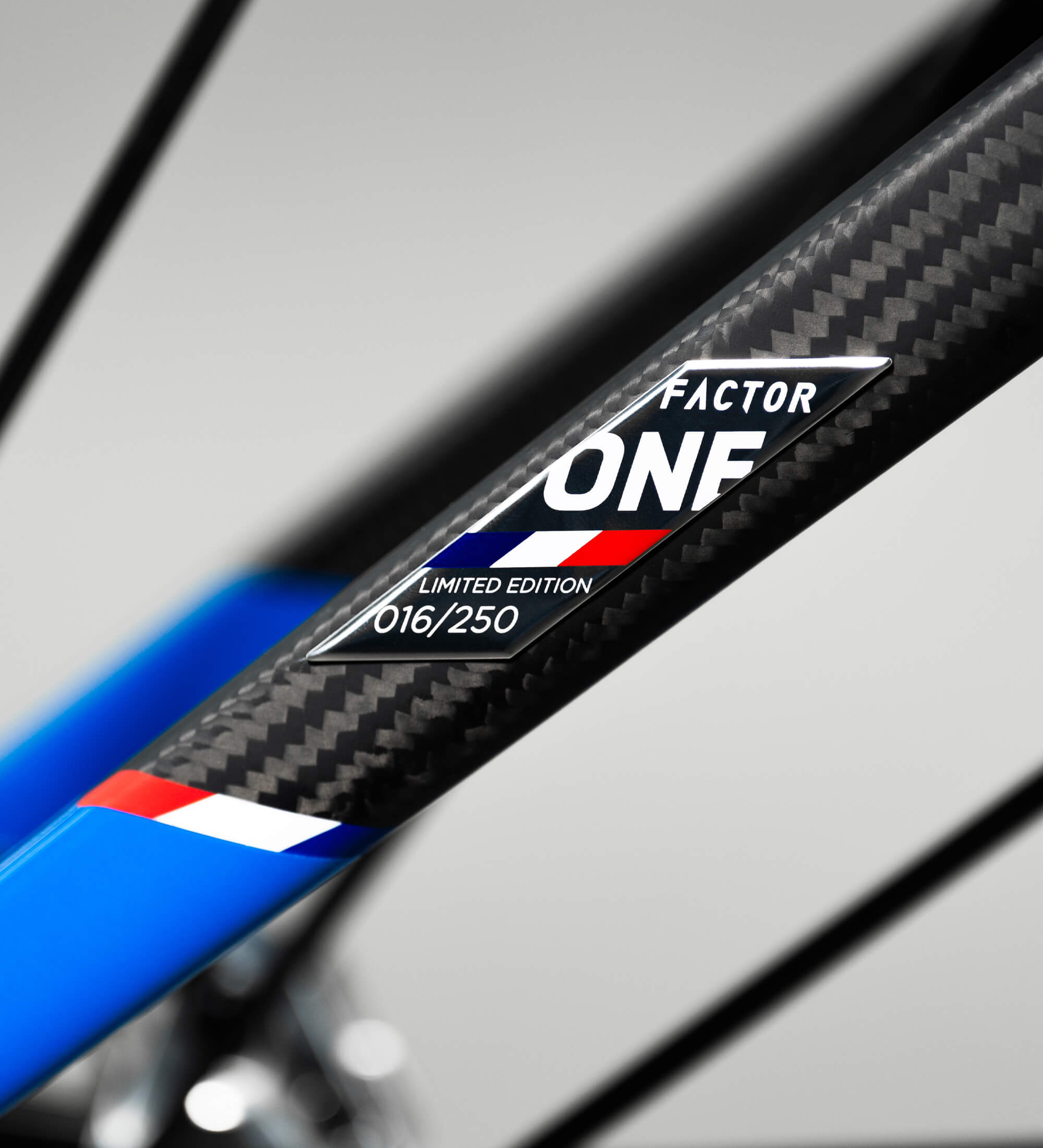 Close-up view of the Factor ONE branded carbon seat stay showing the sharp carbon weave and with French tricolor markings.