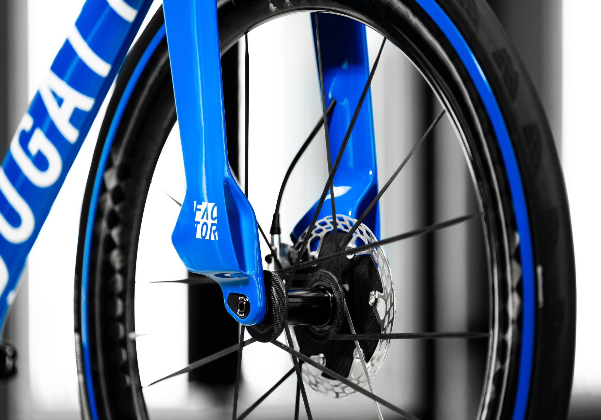 Close-up view of the non-brake side fork flap of the Bugatti Factor ONE fork with part of the down tube and Black Inc wheel visible.
