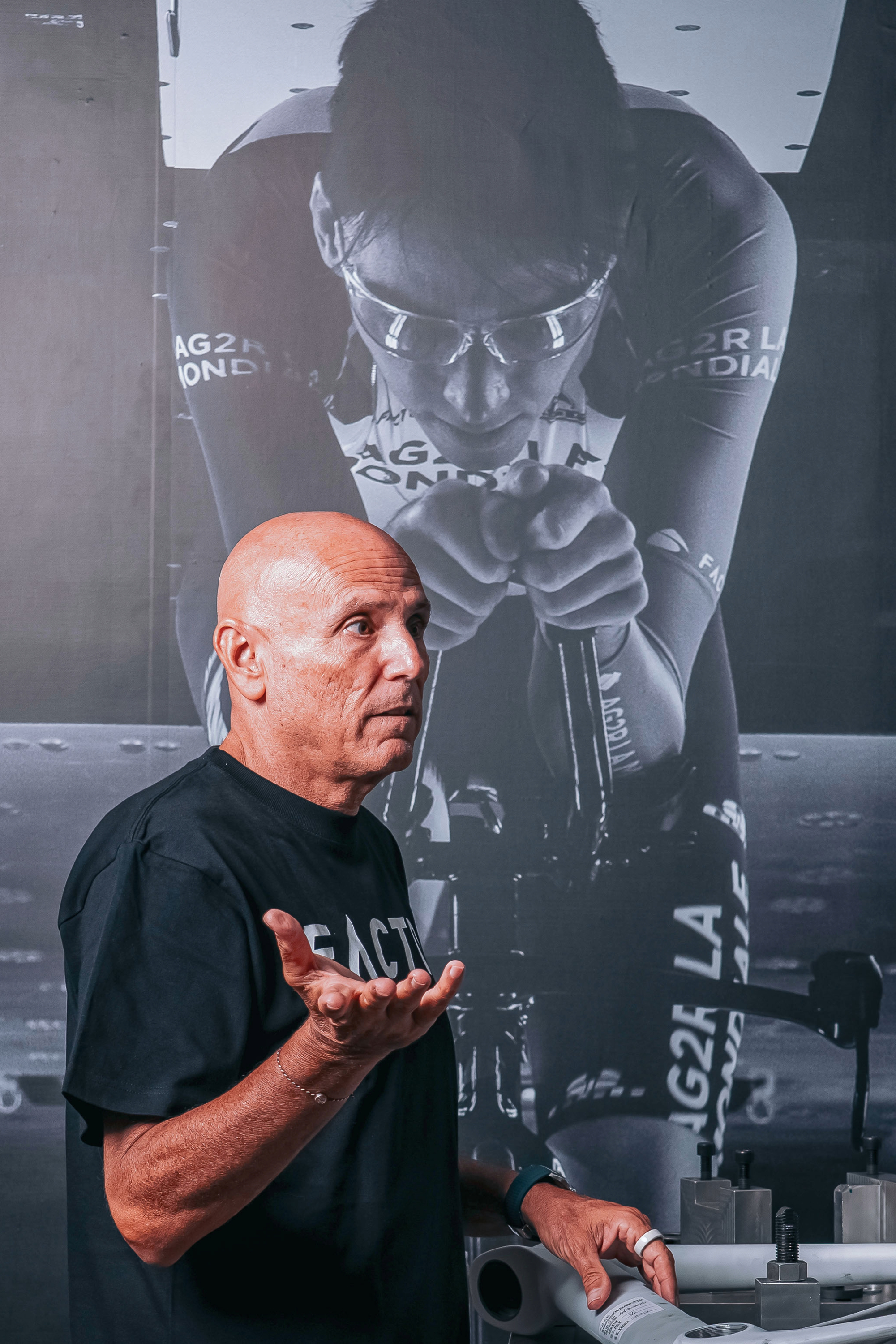 Rob Gitelis speaking in front of Romain Bardet wall