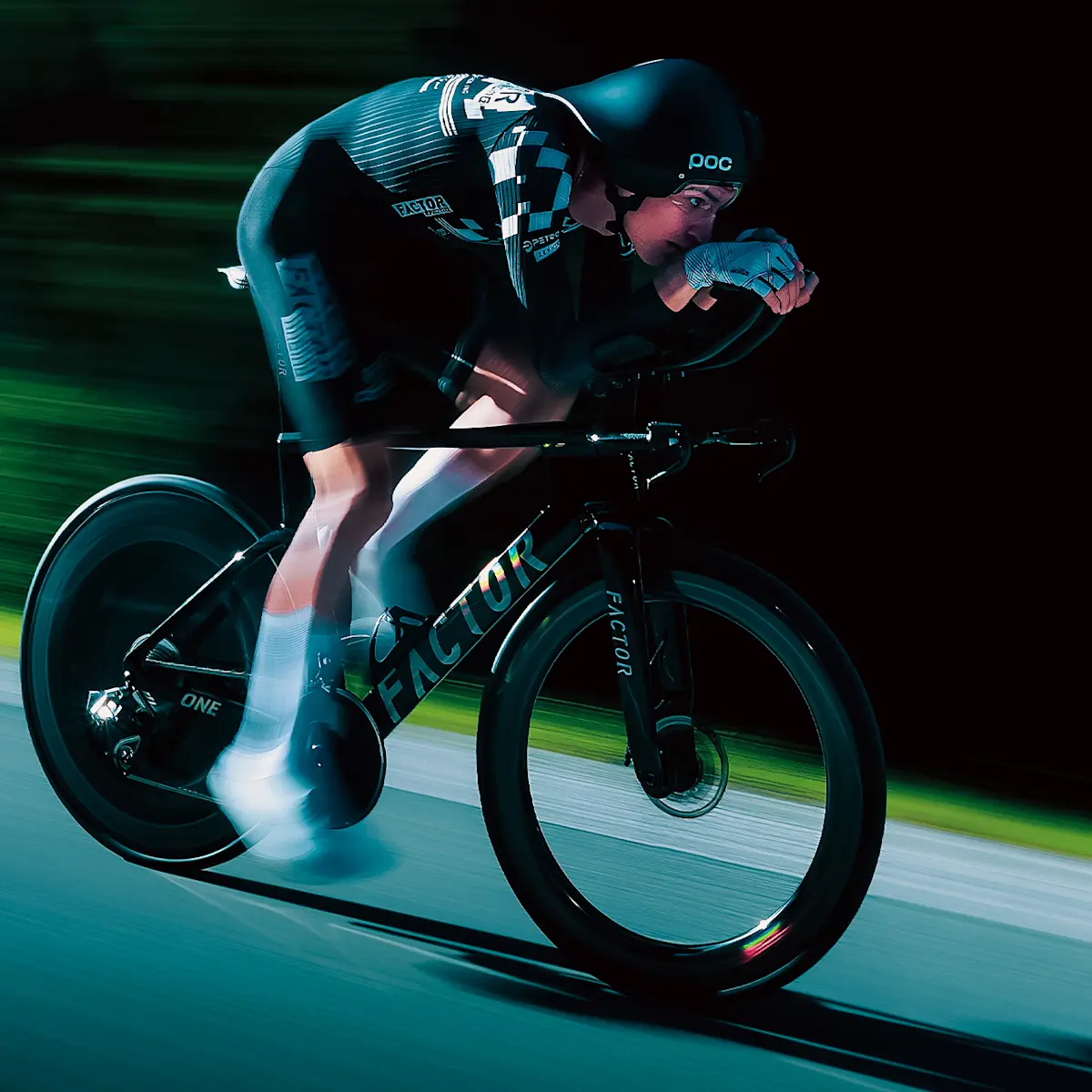 Slightly angled drivetrain side view of a Factor Racing athlete on the ONE SP in Chrome. Blurry legs show the speed.