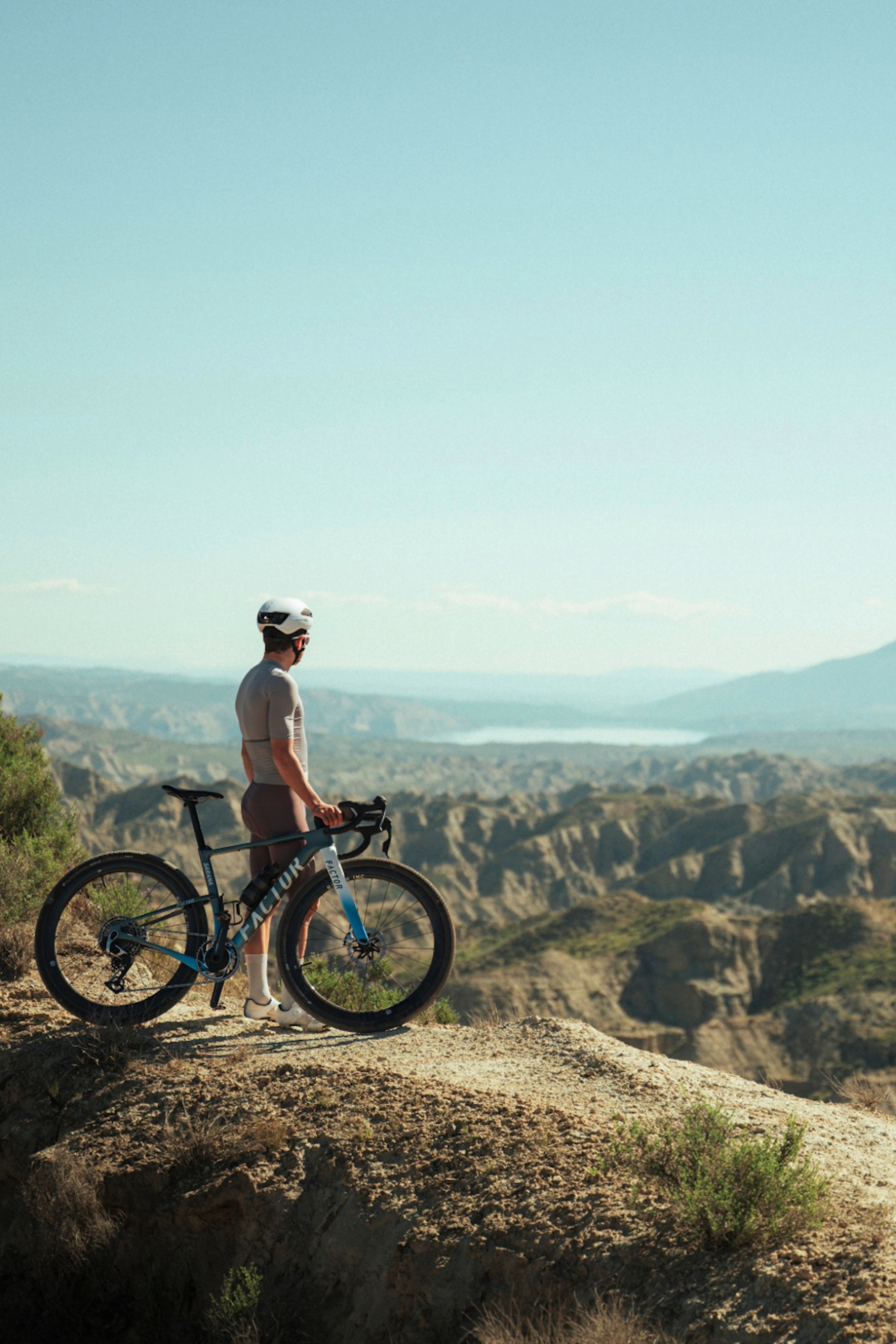 Victor Bosoni with the SARANA looking at the desert standing next to the bike - professional shot