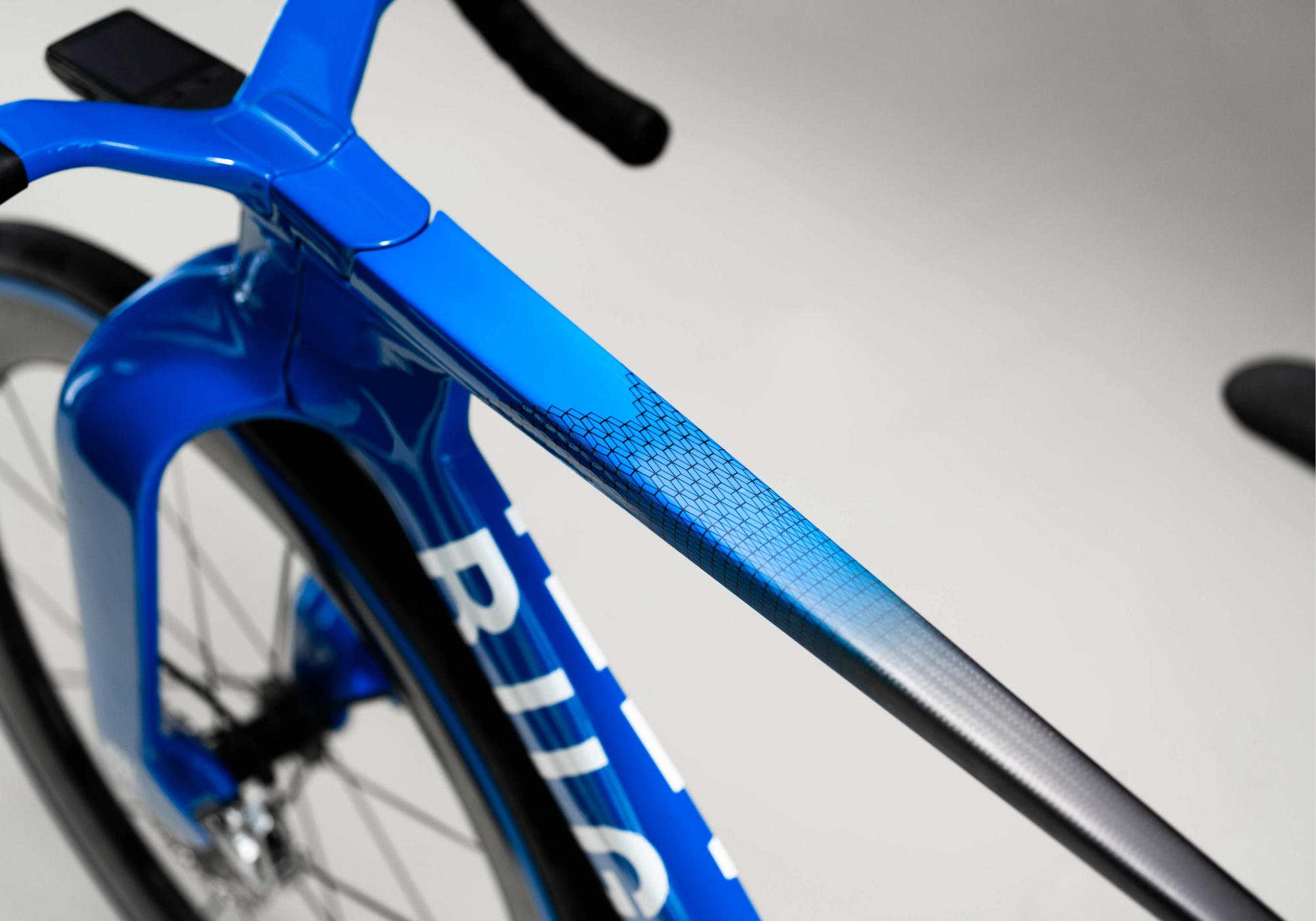 Angled overhead view of the Bugatti Factor ONE top tube with a portion of the down tube, front wheel and fork also visible. 