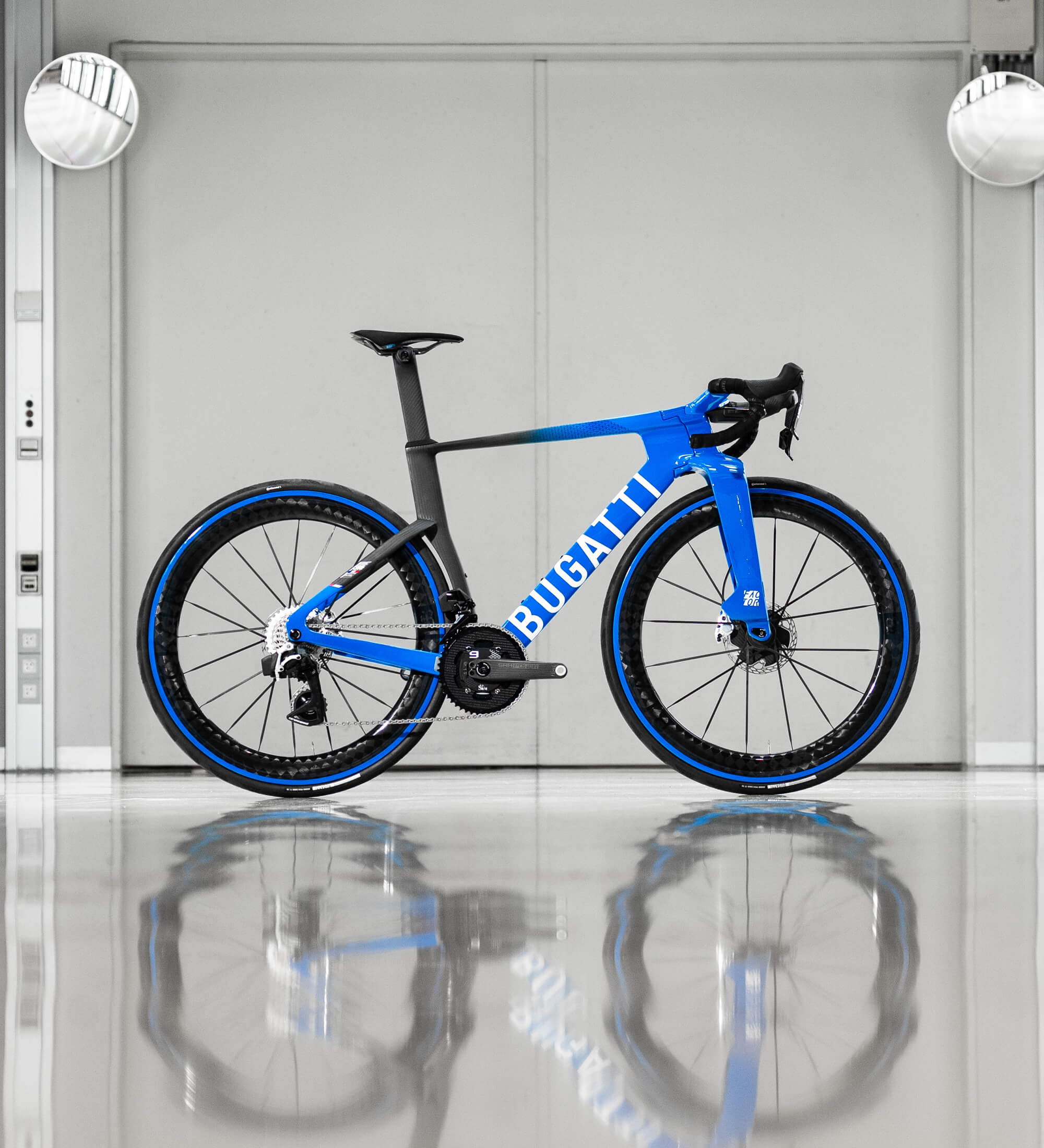 Drivetrain side view of Bugatti Factor ONE in a white room with its shimmering reflection on the floor.