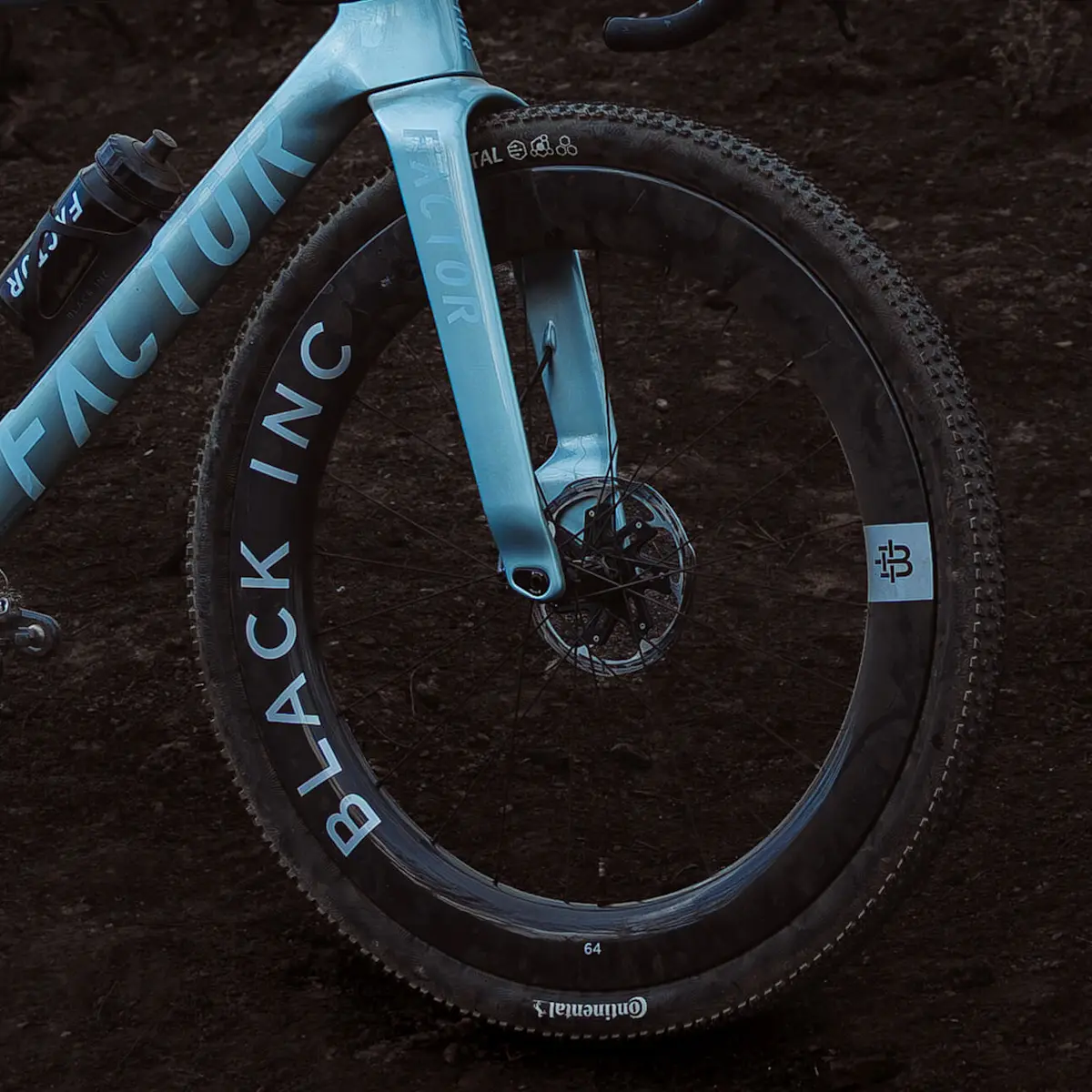 Close-up drivetrain side view of the ELARA aero fork, with Black Inc 64 Gravel wheels. Dark lighting highlights the frame.