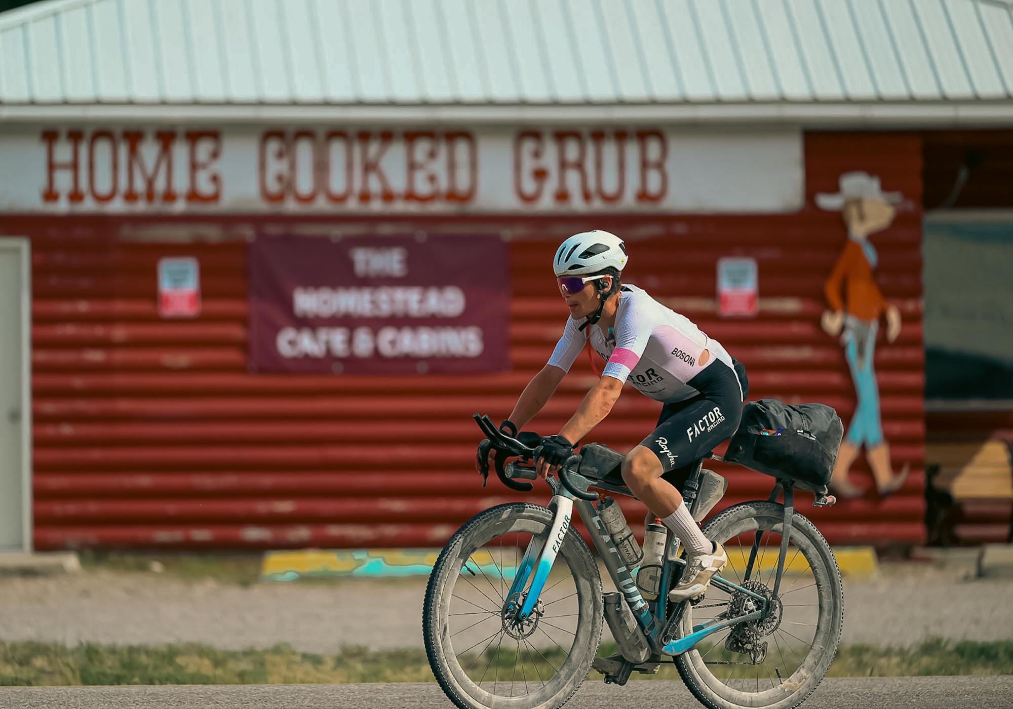 Victor Bosoni riding SARANA through a town - Tour Divide