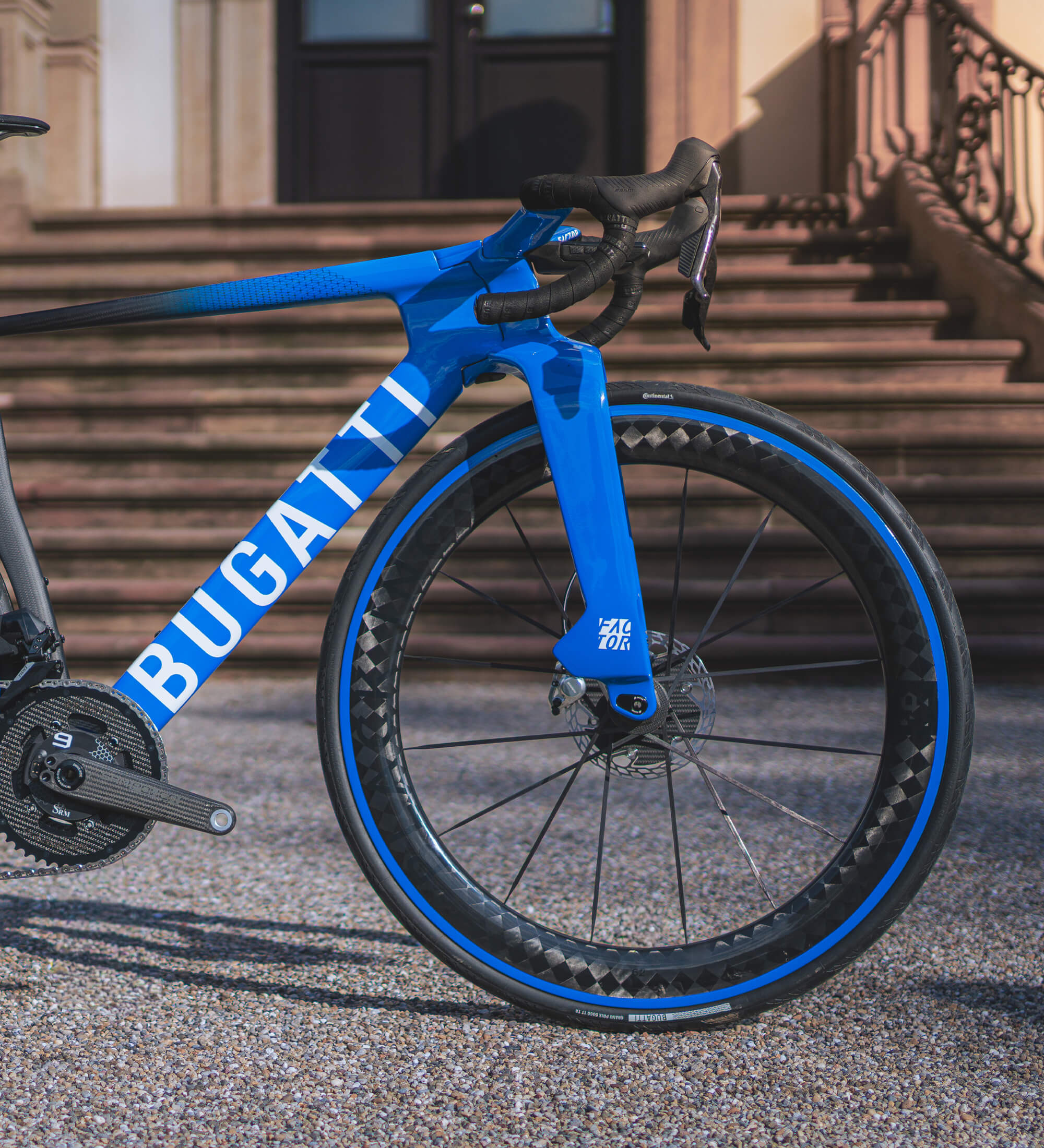 Side view of the front half of the Bugatti Factor ONE in front of the steps of Chateau Saint Jean, the home of Bugatti.