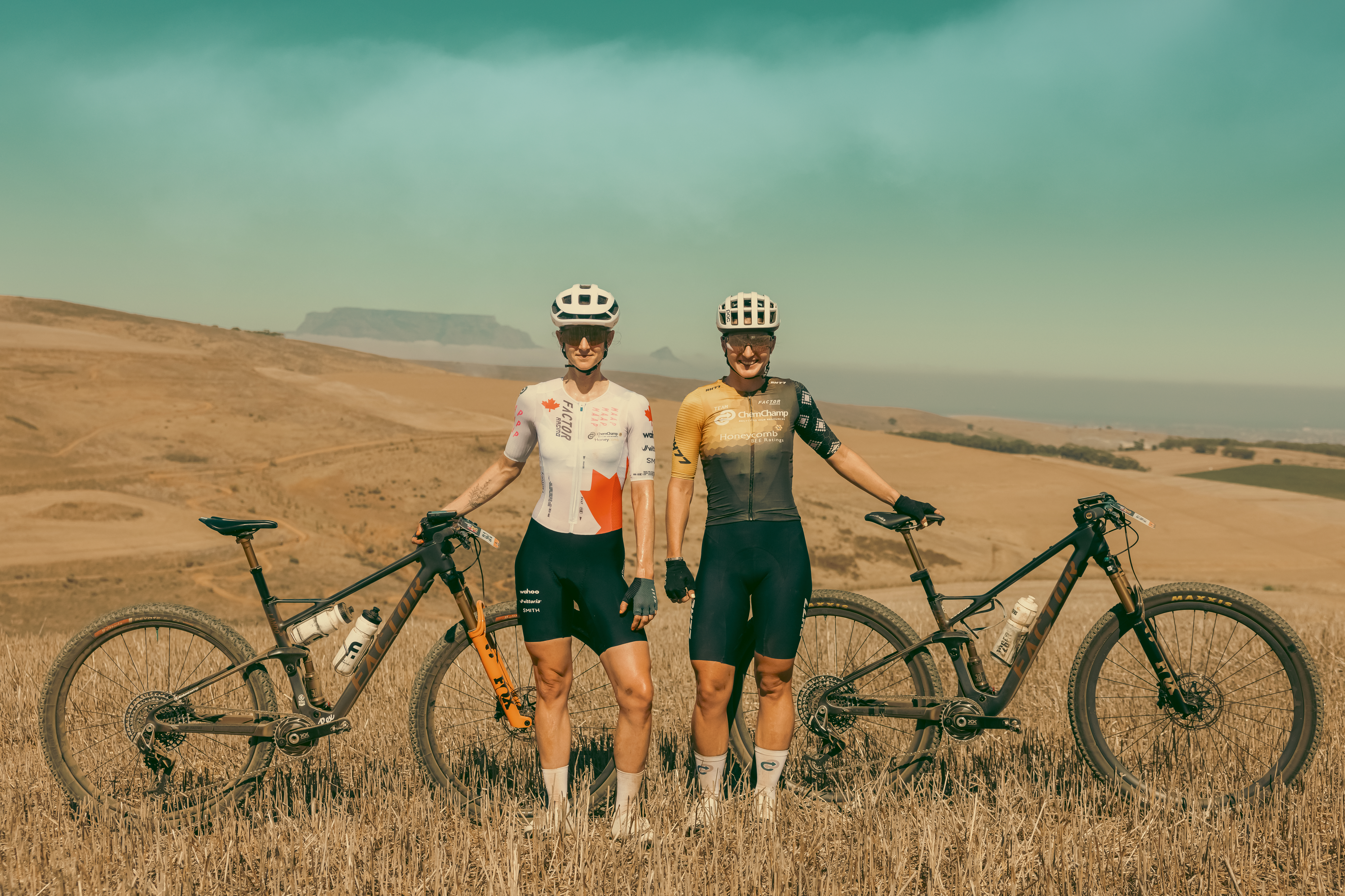Haley Hunter Smith & Hayley Preen standing on a hill next to their Factor LANDO mountain bikes