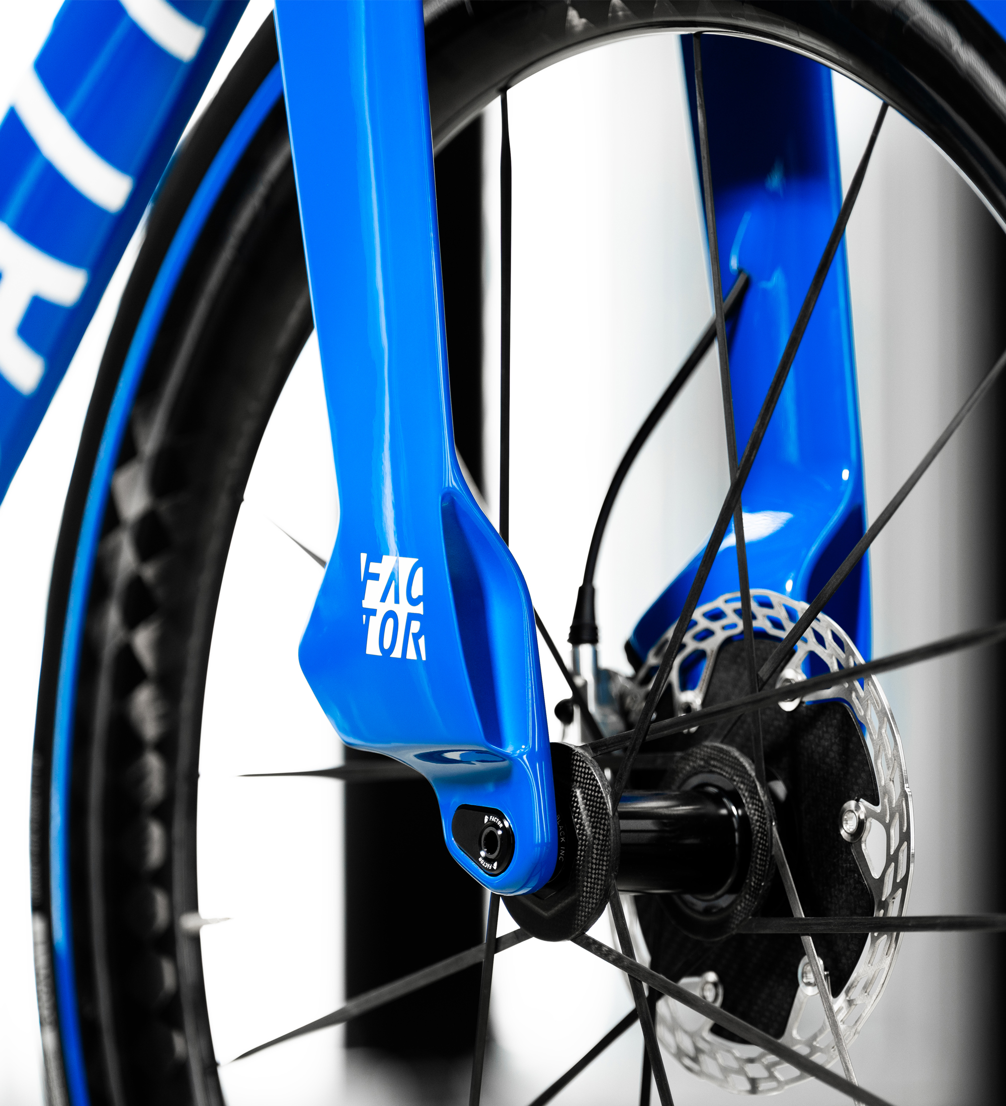 Close-up view of the non-brake side fork flap of the Bugatti Factor ONE fork with part of the down tube and Black Inc wheel visible.