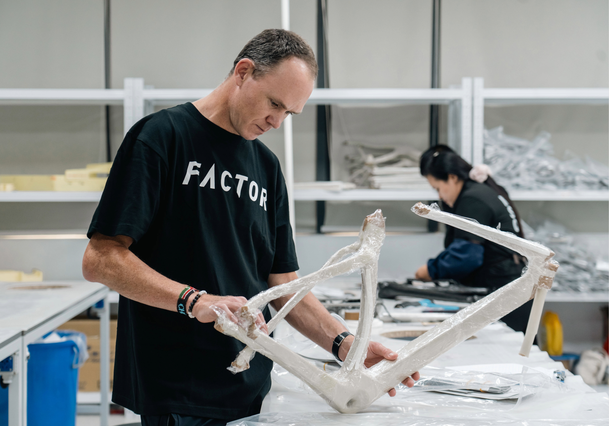 Chris Froome looking at an early stage bike frame at Factor Factory