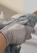 Wrap the hand and arm in a warm damp towel and glide it down to remove scrub