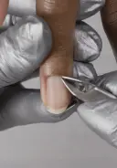Use a cuticle removal tool to remove any remaining cuticle from the nail plate
