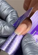Ensure the form fits snugly under the nail's free edge with no gaps or unevenness