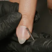 Use a cuticle removal tool to remove any remaining cuticle from the nail