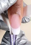 Remove the forms from the nail by gently squeezing the form to release and rocking down