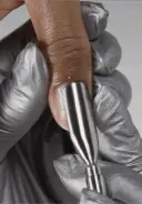 Gently glide a cuticle  pusher along the nail plate