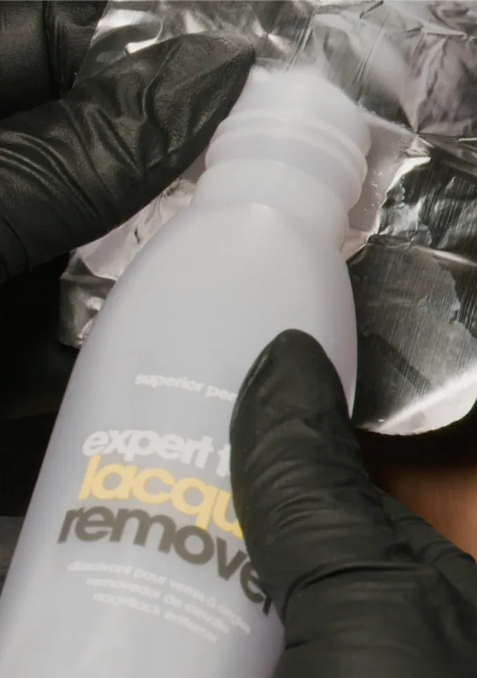 Fully saturate a cotton ball with nail polish remover and place it directly on top of the nail Fully saturate a cotton ball with nail polish remover and place it directly on top of the nail