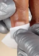 Remove any dust with a manicure brush and cleanse with a nail wipe
