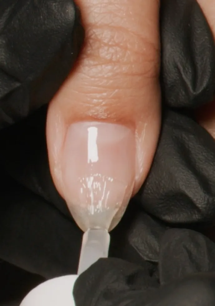 Drain the excess off both sides of the base coat brush and use the corner of the brush to cap/seal the edge of all 5 nails