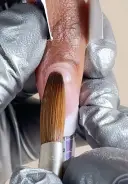 Pick up a medium wet bead and place towards the base of the nail