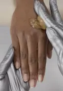 Apply Smooth It Out Hand Foot Scrub in long effleurage strokes to the hand and arm