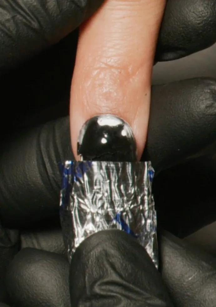 After about 15 min, gently press and twist the foil and cotton off each nail one at a time After about 15 min, gently press and twist the foil and cotton off each nail one at a time