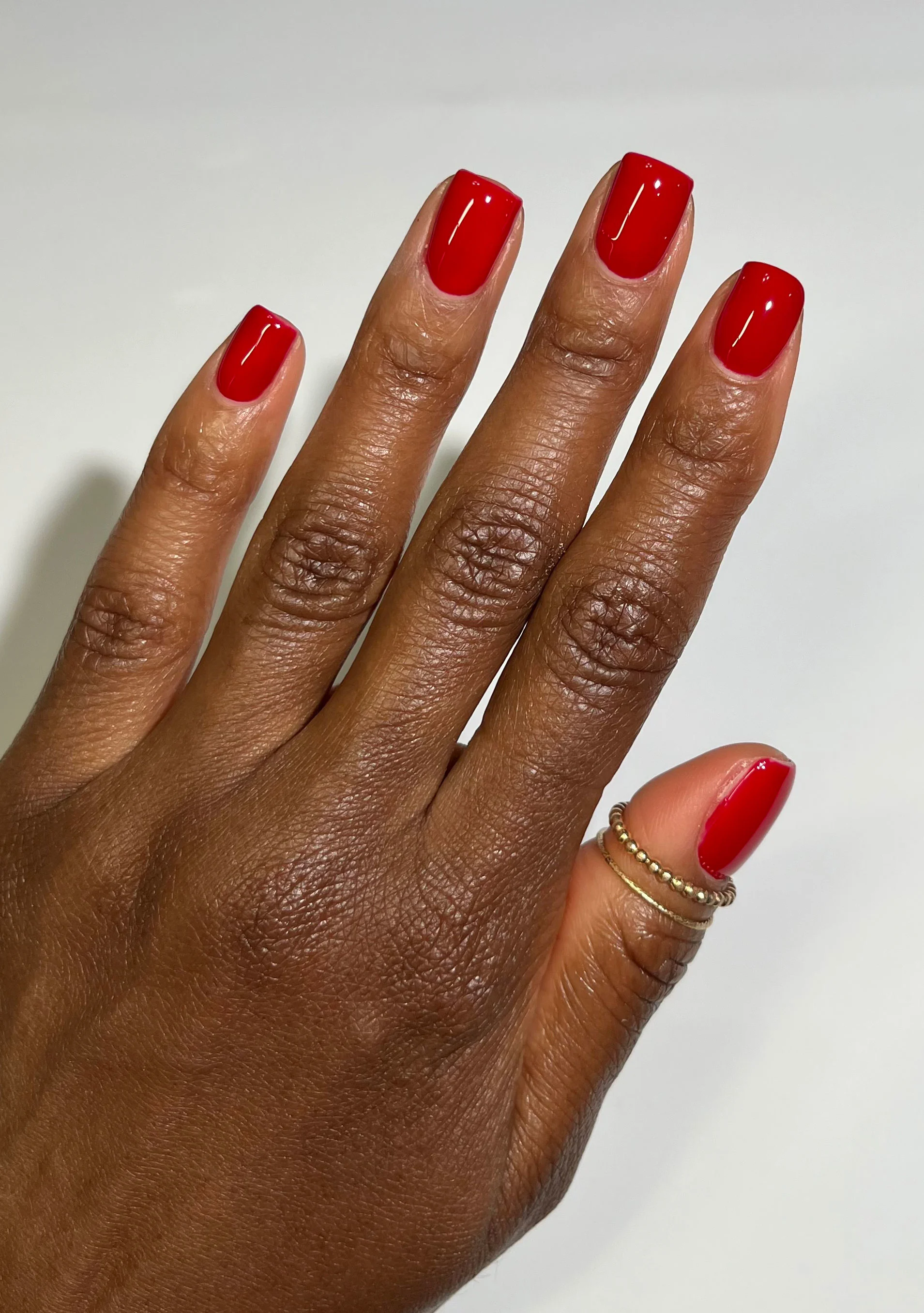 I love selecting tones that complement undertones. Warm skin tones glow in rich reds, chocolate browns, and golden nudes.