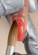 Apply a second bead of product using the tip of the brush to guide the bead back to the cuticle line