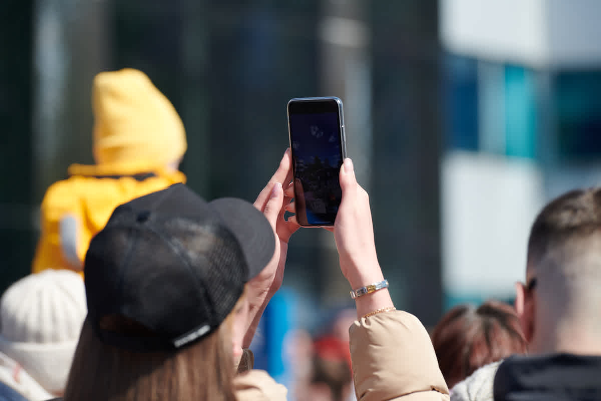 long-haired-woman-in-cap-taking-photos-on-phone-b-2025-03-31-08-06-09-utc 1200x800