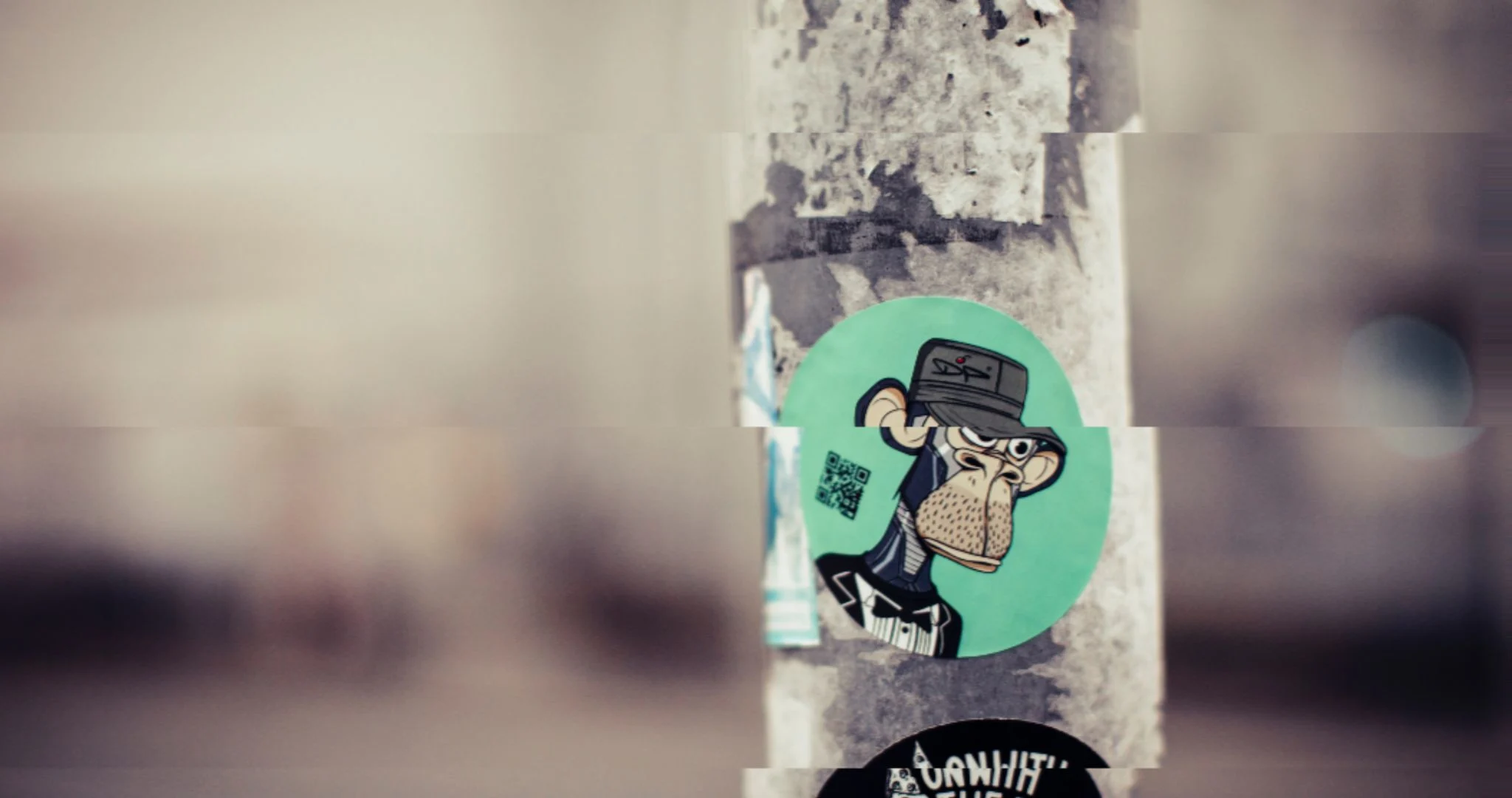 A BAYC NFT print on a sticker on a pole in a city. Source: Markus Spiske / Unsplash