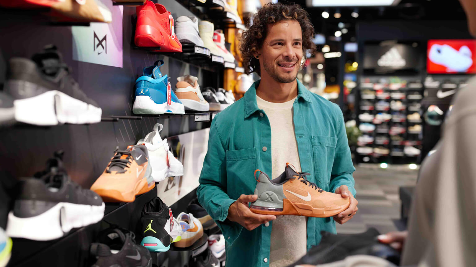 man-in-store-holding-shoe