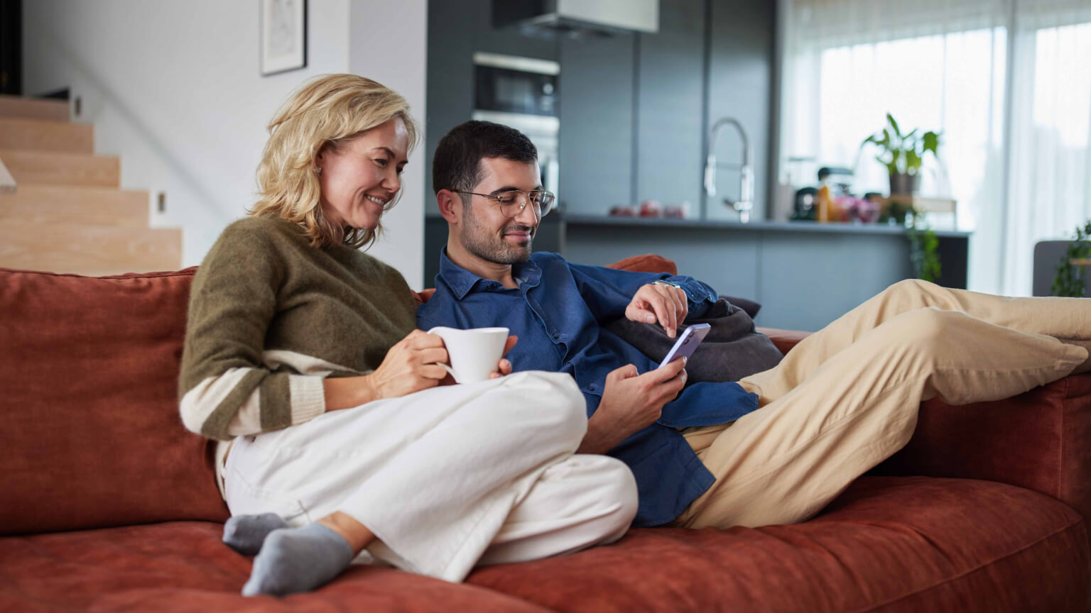 man and woman relaxing on a couch
